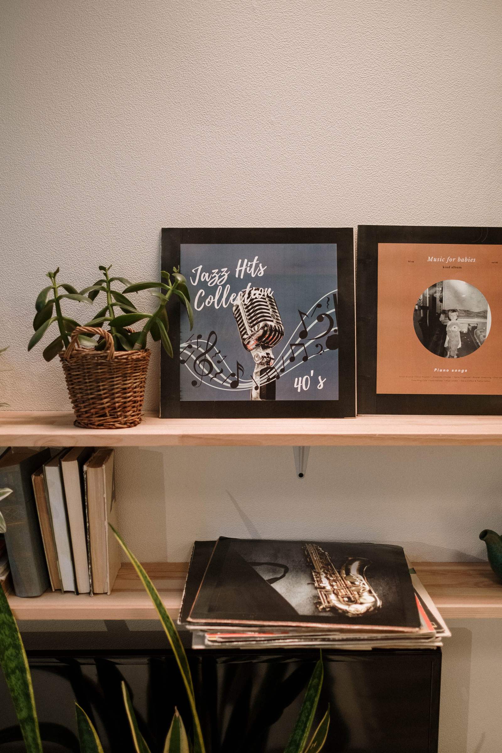 Vinyl records on a shelf in a warmly lit room